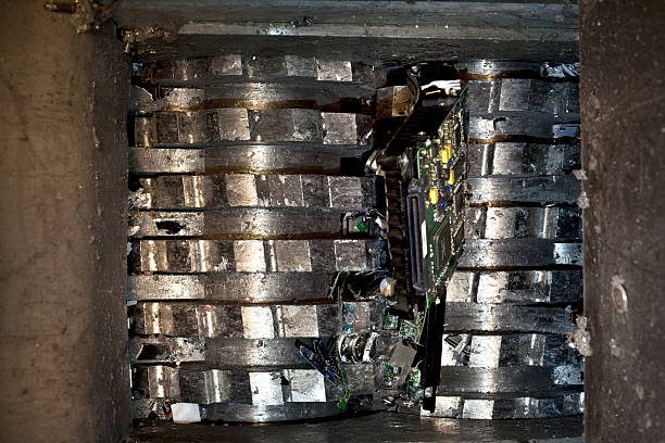 Image of a hard drive shredder in action, ensuring physical data security by destroying electronic devices and preventing potential threats