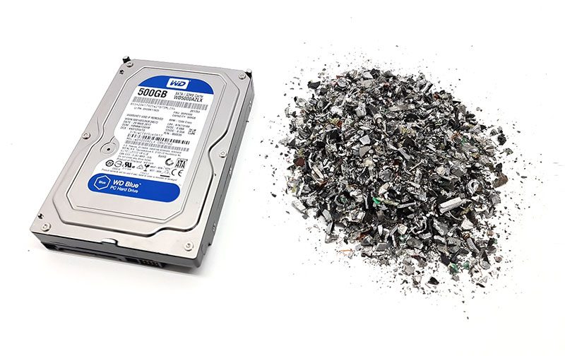 hard drive being shredded showing physical data desstruction per ITAD Certification standards